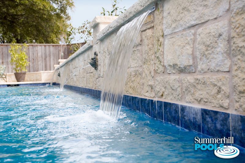 a pool with a water feature on one end