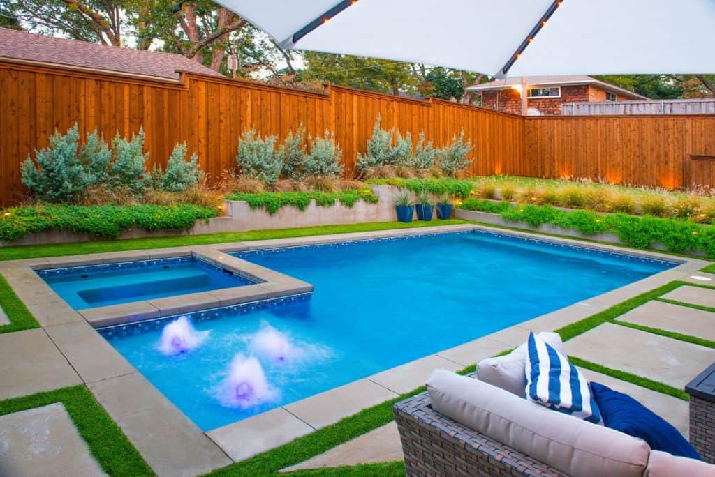 Nice custom rectangle pool with modern landscaping in a backyard