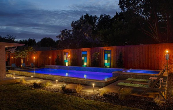 A pool at night lit from both the outside and the inside