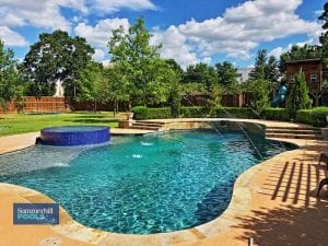 freeform pool with glass tile spa