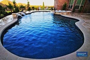 Freeform pool with water feature and spa