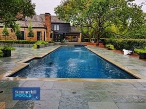 modern pool with new stone decking