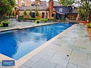modern pool with new stone decking