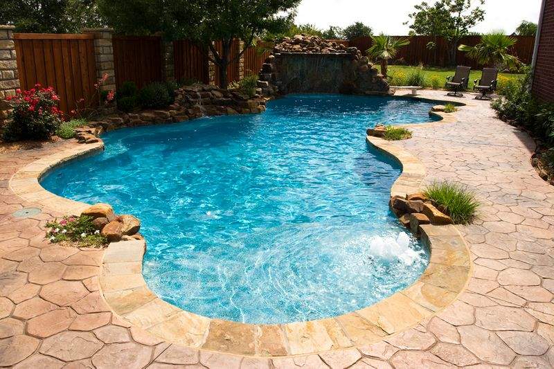 free form pool with huge rock waterfall