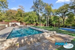 beautiful backyard pool with concrete coping and decking