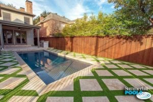 beautiful rectangle concrete pool with stone pavers