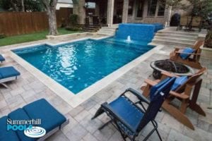 firepit next to a beautiful blue glass pool