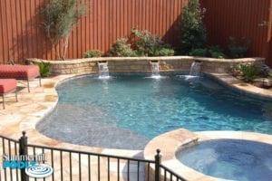 free form pool with stone water wall