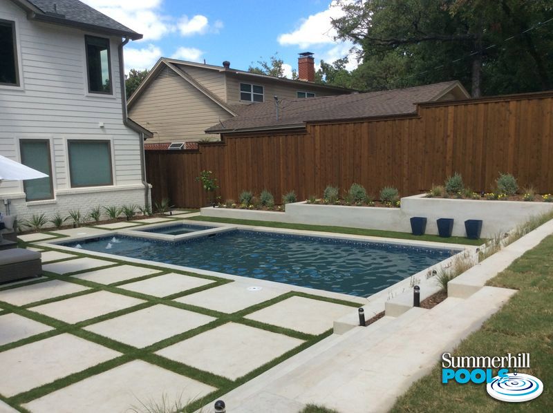 modern pool and spa with a concrete paver decking