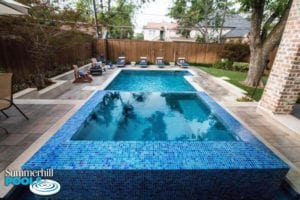 rectangle backyard pool with huge glass tile spa