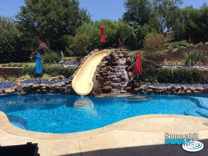 pool with waterfall steps to a slide