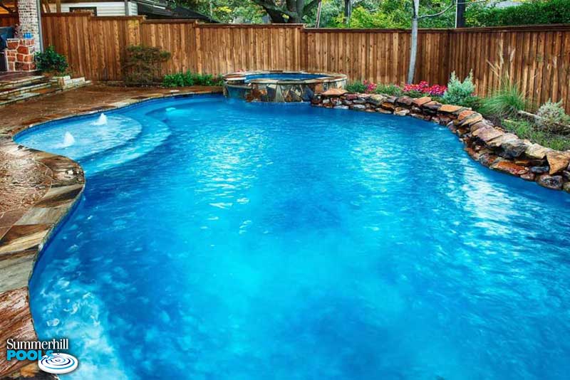 free form pool with rock ledges and spa