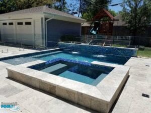 small pool with glass tile raised wall