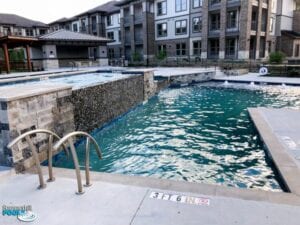 apartment complex pool with tile waterfall