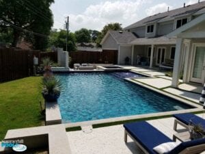 New modern pool with concrete paver decking.